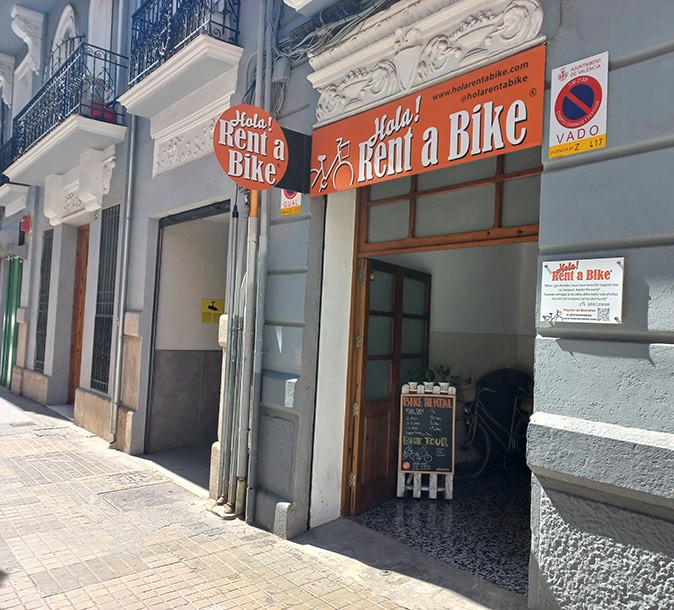Starting a business in Spain The exterior of a bike rental business in Spain with the name 'Hola! Rent a Bike'