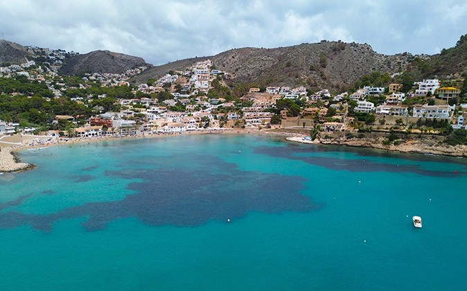 Moraira's beautiful coastline Aerial view of a coastline with several houses and azure blue water