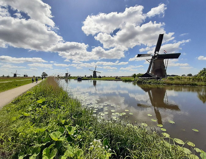 Holland or Netherlands several windmills lined up along a canal
