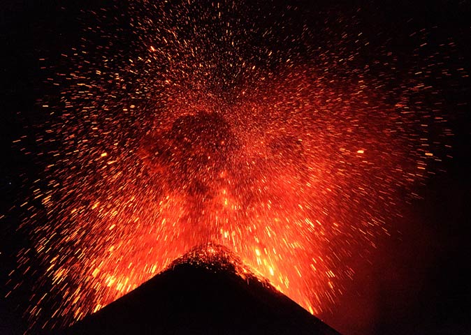 the Volcan De Fuego erupting at night