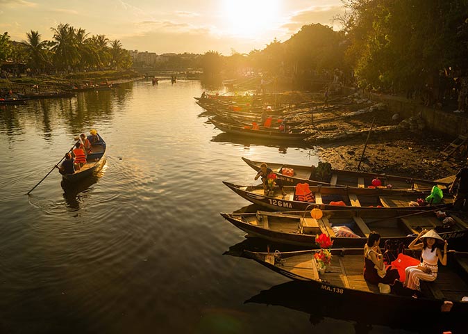 traditional boats at sunset on the Red River