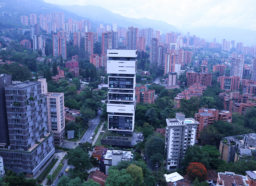 Aerial view of a city with a lot of highrise builldings and mountains in the background