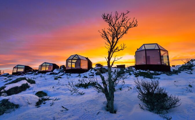 glass houses surrounded by a snowy landscape