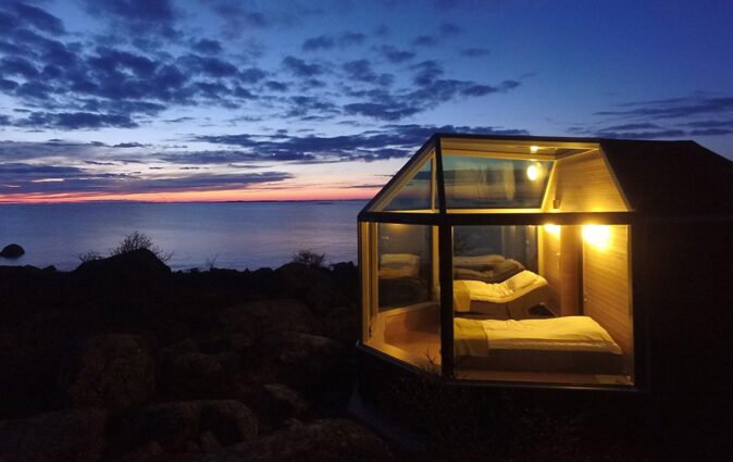 a glass house with 2 beds
