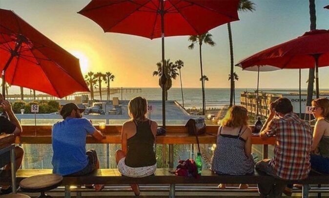 One of the best rooftop bars in San Diego, California people watching the sunset at a rooftop bar