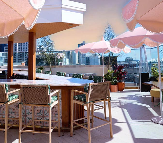 rooftop bar in San Diego high chairs and umbrellas on a rooftop bar