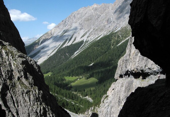 Best views in Switzerland: Uina Gorge View through two high rocks into a green and gray gorge