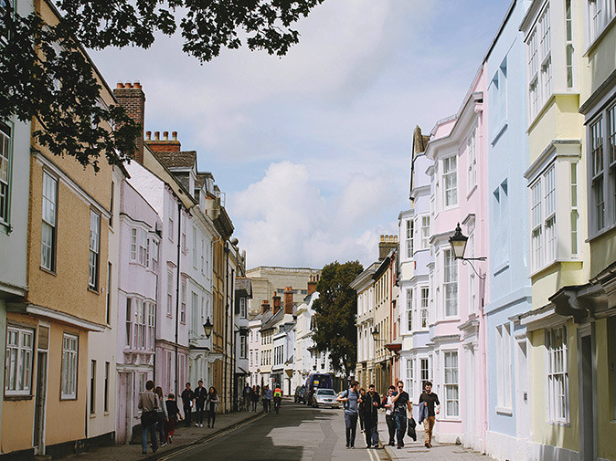 Crime and safety in Oxford A street lined with colorful houses, with several pedestrians