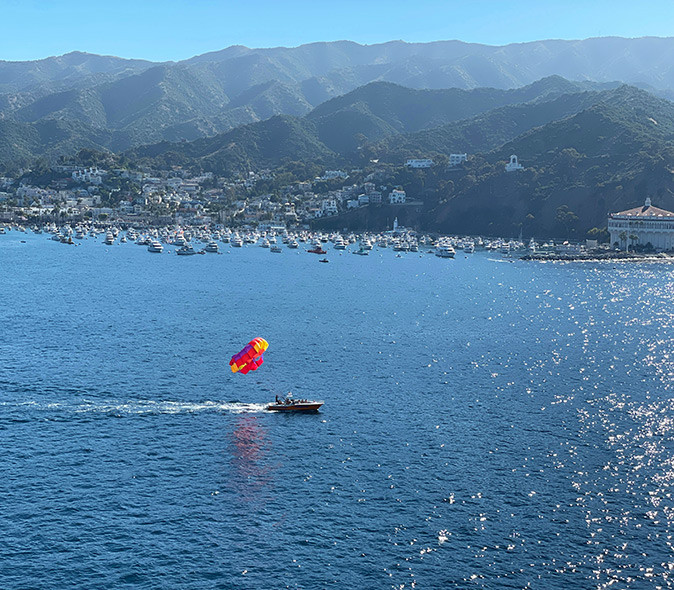 Parasailing, a great thing to do on Catalina Island A speedboat with someone prasailing off the coast of Catalina Island