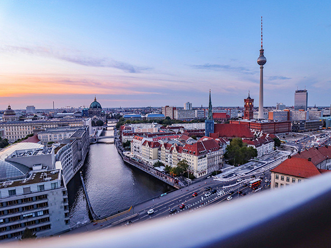 Moving to Berlin, Germany Aerial view of the skyline of Berlin showing a mix of buildings and a large river