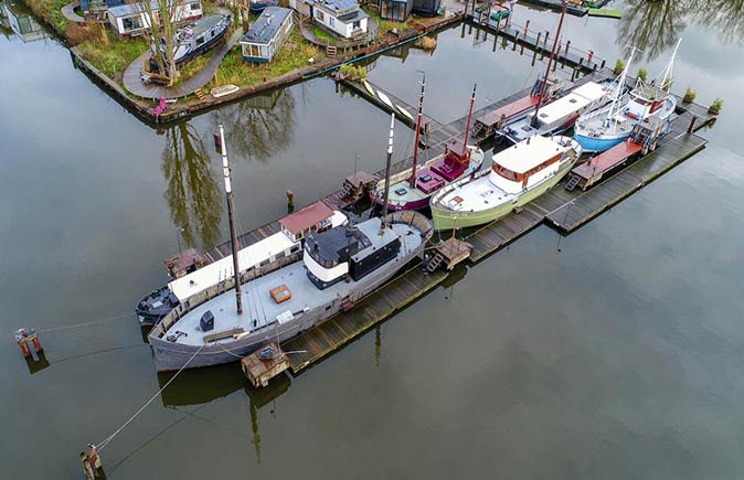 a unique place to stay in Amsterdam 6 traditional boats docked, seen from the air