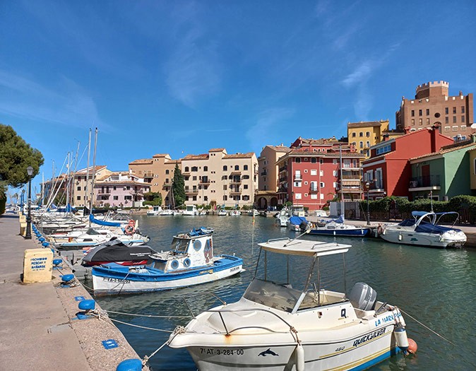 One of the easiest day trips from Valencia A marina filled with small motorboats and sailboats, surrounded by colorful houses