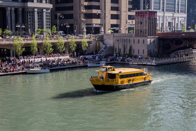 River taxi with the riverwalk in the background River taxi with the riverwalk in the background