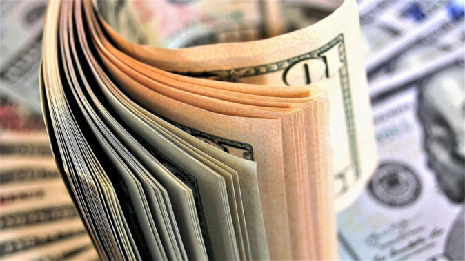 dealing with taxes when moving to New York a stack of dollar bills