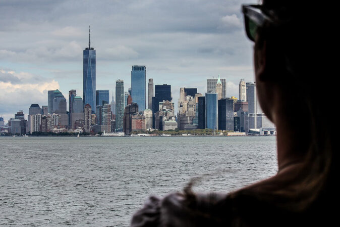 moving to NYC woman looking out over New York after moving there