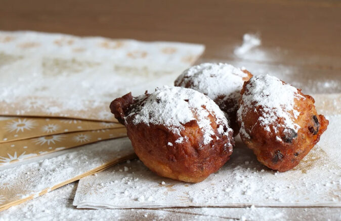 Oliebollen: traditional Dutch food for Christmas 3 oliebollen with powdered sugar