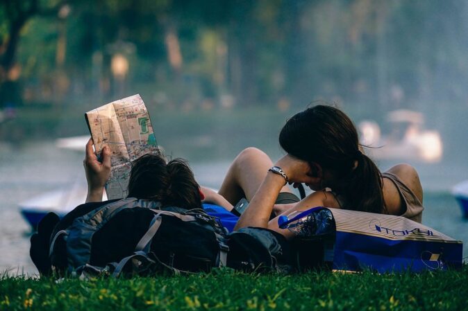 a traveling couple looking at a map a traveling couple looking at a map