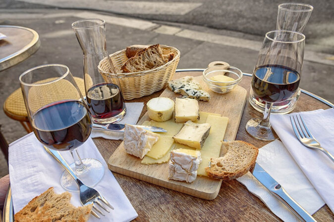 Making new friends while eating French cheese in Paris - why travel a table in Paris with wine and cheese