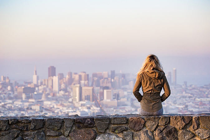 a woman contemplating what to do before moving abroad