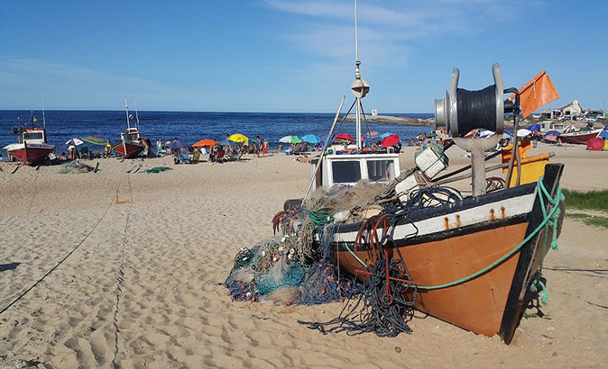 Punta del Diablo, one of the best places to visit in Uruguay A fishing boat on the beach in Punta del Diablo