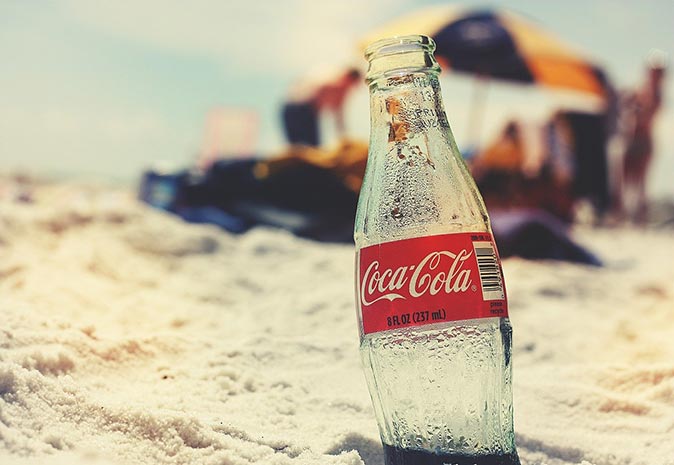a coca cola bottle on the beach a coca cola bottle on the beach