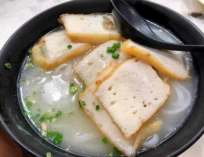 a bowl of fish cake noodle soup