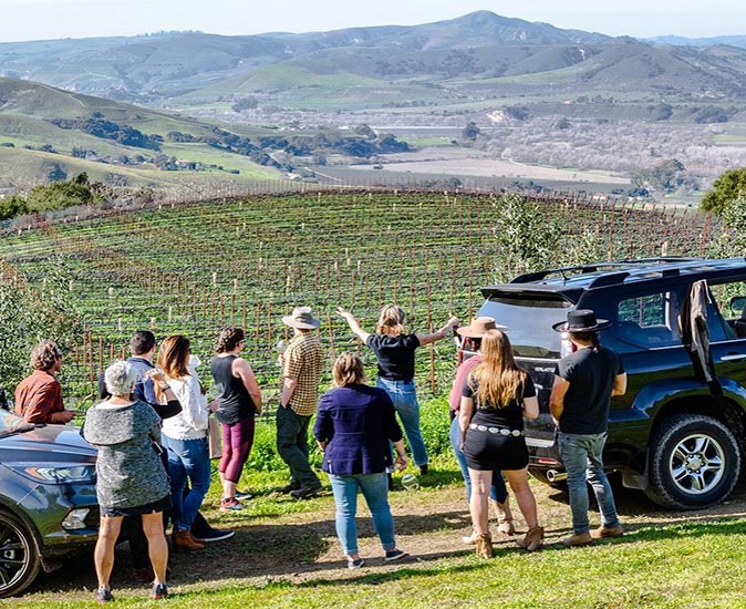 a group of people on a vineyard tour in Los Alamos