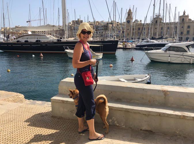 Sarah walking her dog Sarah with her dog, enjoying life in Malta