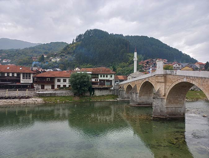 houses on the river next to a bridge in Konjic