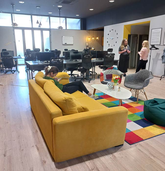 the main area of Code Hub coworking space with 3 women in the background