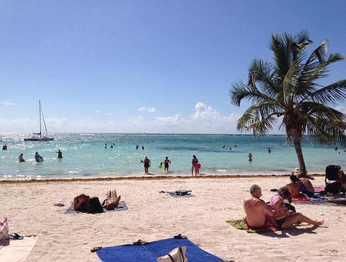 several people on a beach in Akumal