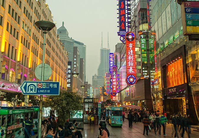 visit Nanjing Road in Shanghai busy Nanjing Road with a lot of neon signs