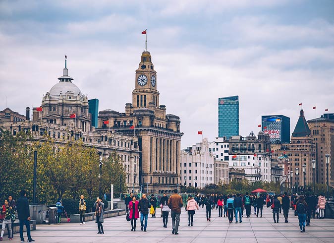 The Bund, Shanghai a large number of people walking around the Bund in Shanghai