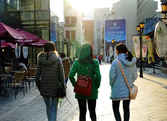 Walk to explore parts of Shanghai 3 women photographed from behind, walking in Shanghai