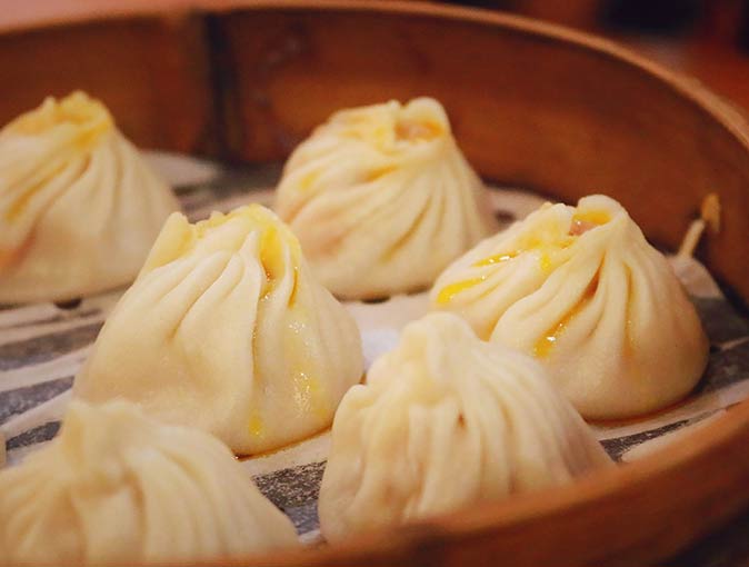 Eat Xiao Long Bao when travelling to Shanghai a close up of 6 Xiao Long Bao dumplings