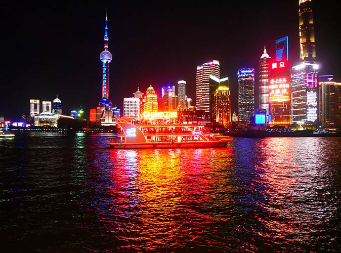 go on a boat ride on the Huangpu River when you visit Shanghai a boat on the Huangpu River at night