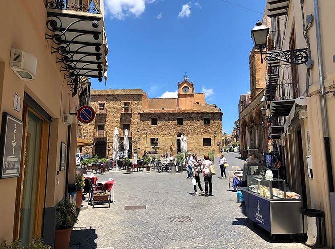 Castelbuono, one of the best small towns in Italy a central square in a small Italian town with several seats and people