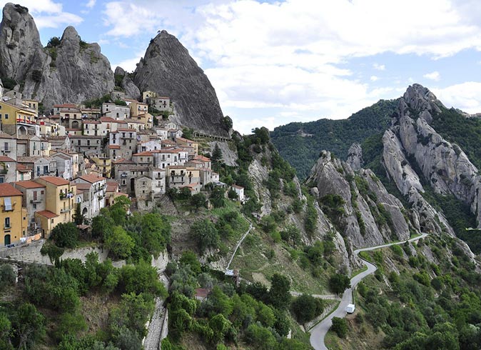 Castelmezzano, one of the best small towns in Italy a beautiful small town perched on a hill surrounded by greenery and mountains
