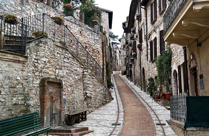 Spello, one of the prettiest small towns in Italy a narrow street with historic stone houses on both sides