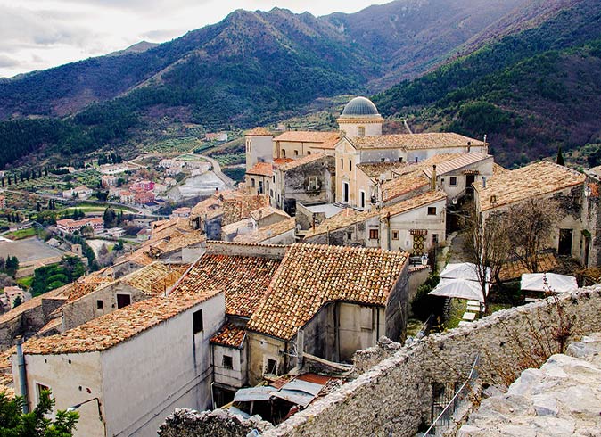 Morano Calabro, a small town in Italy to visit orange roofs of a cluster of houses in a small town in Italy surrounded by mountains