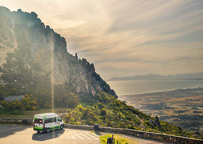 A van parked along the garden route, looking out towards the sea