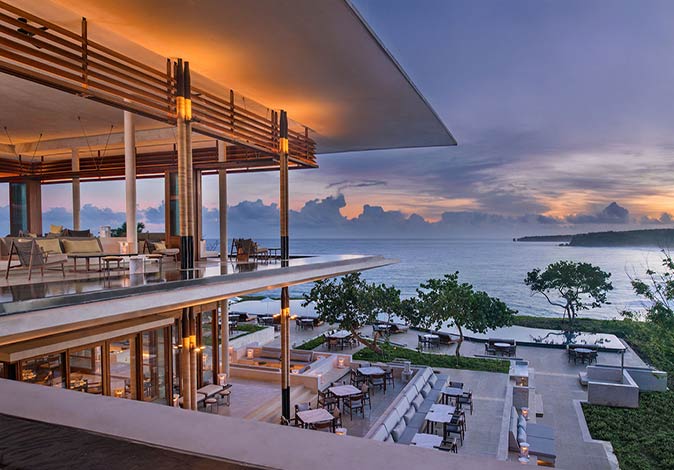 Amanera, one of the luxurious hotels in the Caribbean a luxurious restaurant with outdoor seating looking out towards the sea at sunset