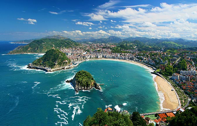 San Sebastian, one of the best places to live in Spain a bay with a sandy beach surrounded by houses