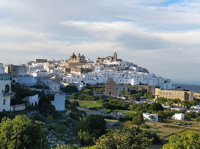an aerial view of a town on a hill with mainly whitewashed buildings