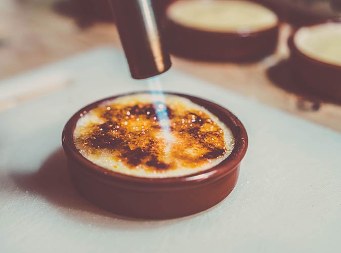 a clay dish with a typical creamy Spanish dessert