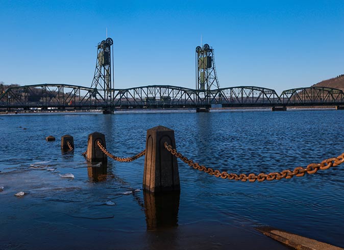 a large bridge and a metal chain across a river
