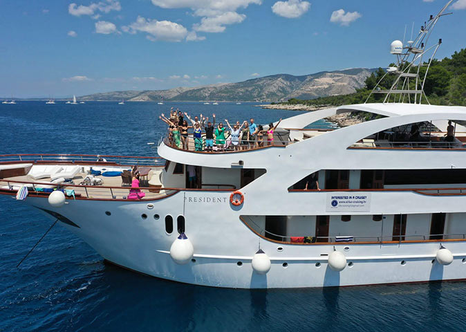 A group of people on deck of a luxury small ship cruise