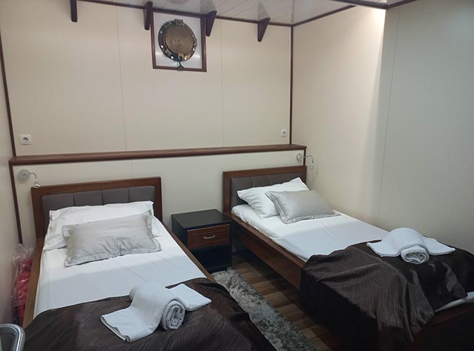 A cabin on a small ship cruise with two twin beds