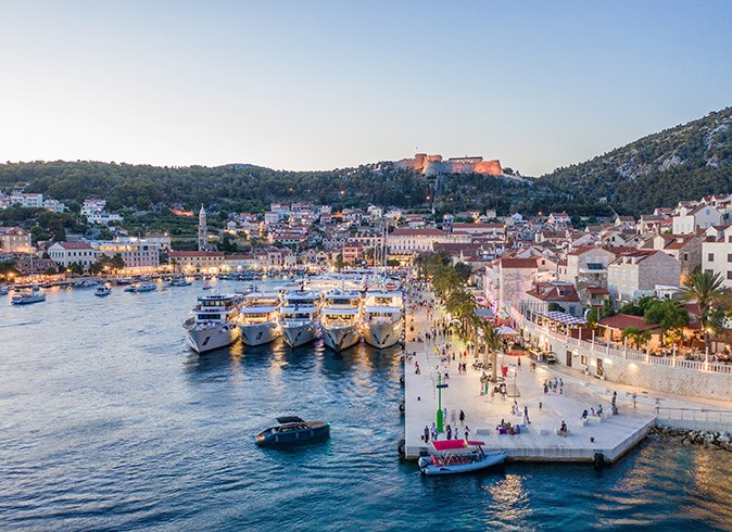 An aerial view of the port of Hvar with several small ship cruises and other yachts