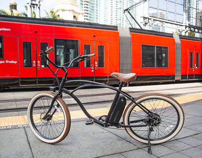 a red trolley with an electric bicycle in front of it